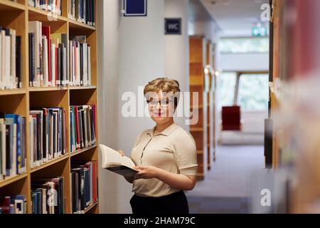 Young female student in library Stock Photo