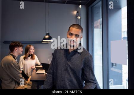 Smiling man in office looking at camera Stock Photo