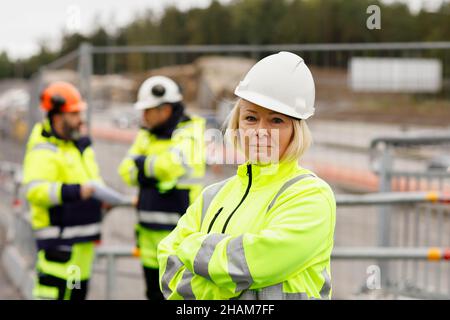 Engineers in reflecting clothing at building site Stock Photo