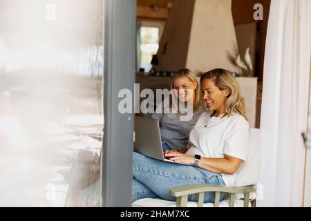 Smiling women using laptop Stock Photo