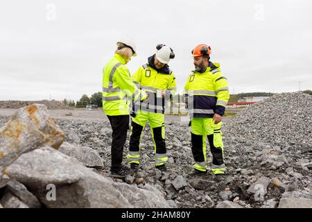 Engineers in reflective clothing having hot drink Stock Photo