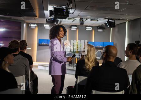 TV show host interviewing audience member Stock Photo