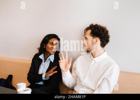 Coworkers talking to each other Stock Photo
