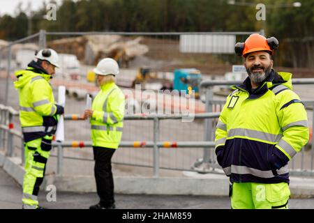 Engineers in reflecting clothing at building site Stock Photo