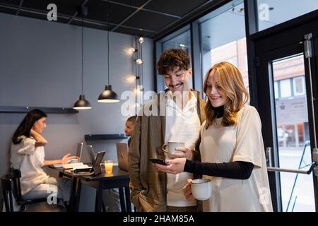 Coworkers having coffee break in office Stock Photo