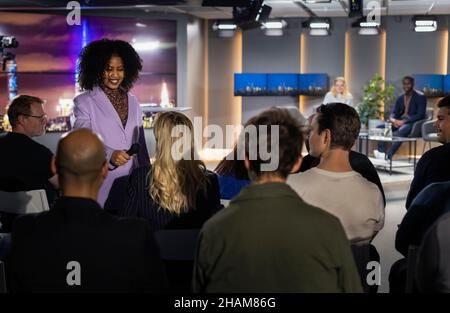 TV show host interviewing audience member Stock Photo