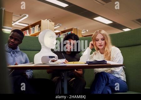 Friends sitting together in library Stock Photo