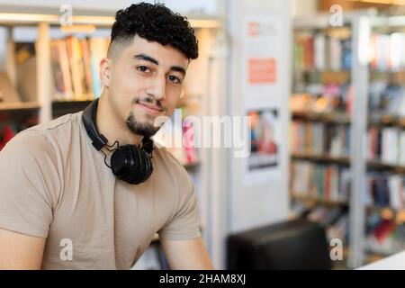 Young man studying in library Stock Photo