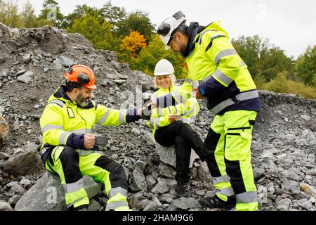 Engineers in reflective clothing having hot drink Stock Photo