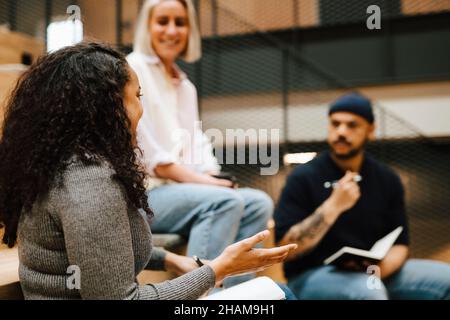 Coworkers talking at corridor Stock Photo