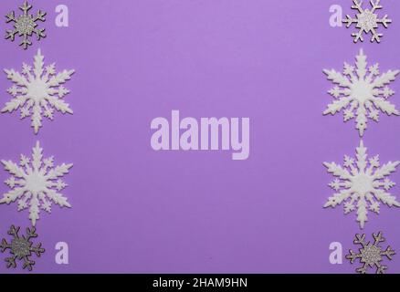 Christmass flatlay white snowflakes in shape frame and silver snowflakes Stock Photo