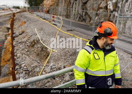 Male engineer in reflecting clothing at building site Stock Photo
