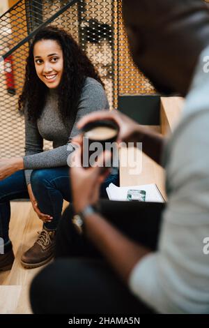 Smiling woman talking to man Stock Photo