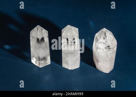 Collection of crystals quartz on dark blue background with shadows. Top view. Copy space Stock Photo