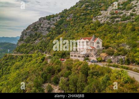 Abandoned hotel in the mountains, near Lake Skadar, Montenegro. Aerial view. Stock Photo