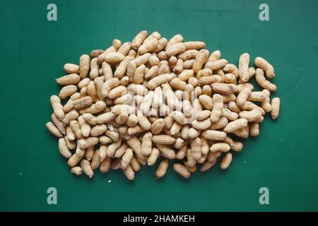 many peanuts on a dark green background top view  Stock Photo
