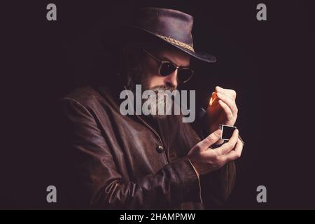 Bearded man in a cowboy hat a weary expression on his face. Stock Photo