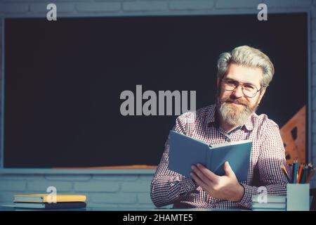 Smiling senior man reading book and smile. Stock Photo
