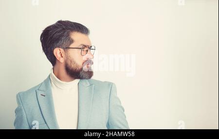 Side view portrait of serious fashionable handsome man in blue suit. Stock Photo