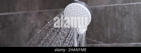 Cheap tap is pouring rain in the bathroom closeup Stock Photo