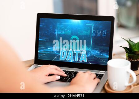 Text showing inspiration Data. Word Written on Piece of information Facts and statistics collected as reference Hand Typing On Laptop Next To Coffee Stock Photo