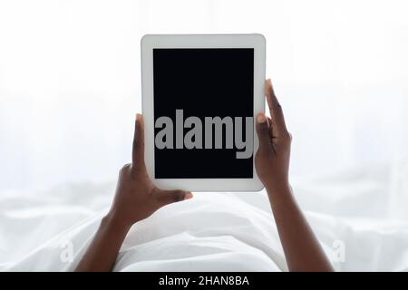 Female hands holding digital tablet with empty screen Stock Photo