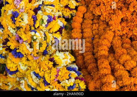 Colorful flower garlands for votive religious offerings for sale in a market in Durbar Square in Kathmandu, Nepal. Stock Photo