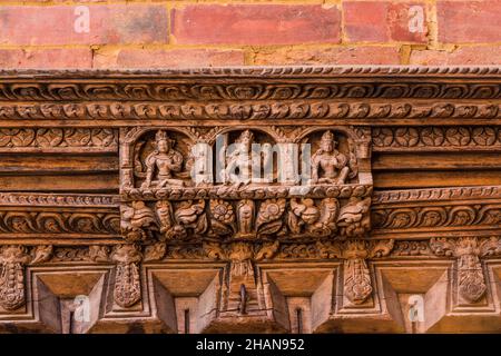 Intricate wood carvings of Hindu deities over the door to the Sundari Chowk in the old royal palace in Durbar Square, Patan, Nepal. Stock Photo
