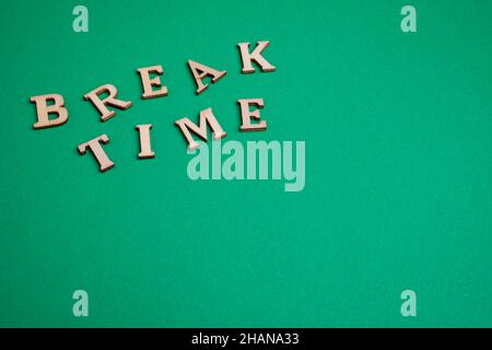 Break time word written with wood letters. break time text on green background - copy space Stock Photo