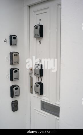 Flat complex with multiple master lock key access points on entrance door. Stock Photo