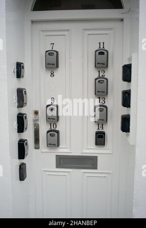 Flat complex with multiple master lock key access points on entrance door. Stock Photo