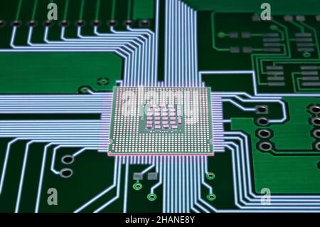 macro photo of printed circuit board with illuminated wires and central processor unit Stock Photo