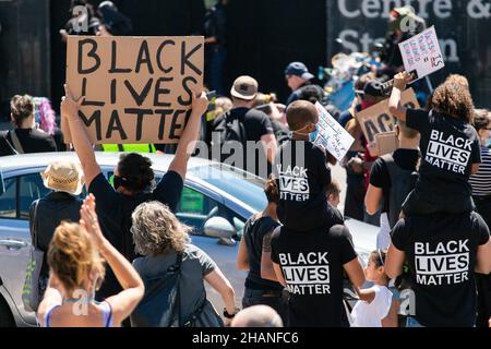 Black Lives Matter Protestors with children and BLM sign Brighton 2020 Stock Photo