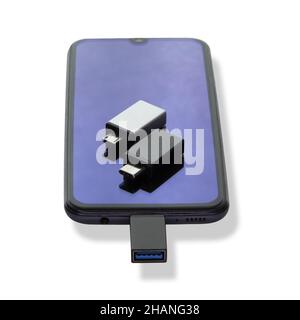 Phone or smartphone with USB OTG data transfer connected to a USB flash drive, read and write any information from portable information sources Stock Photo
