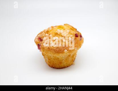 Cranberry and Orange Muffin with orange zest topped with sweet sugar pearls and redcurrants with Jaffa centre. Stock Photo
