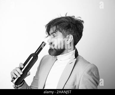 Anonymous alcoholic person drinking from a bottle of alcohol. Stock Photo
