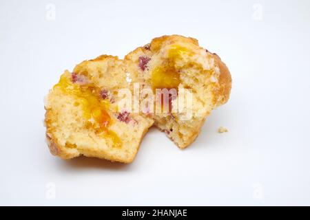 Cranberry and Orange Muffin with orange zest topped with sweet sugar pearls and redcurrants with Jaffa centre. Stock Photo