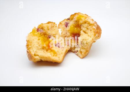 Cranberry and Orange Muffin with orange zest topped with sweet sugar pearls and redcurrants with Jaffa centre. Stock Photo