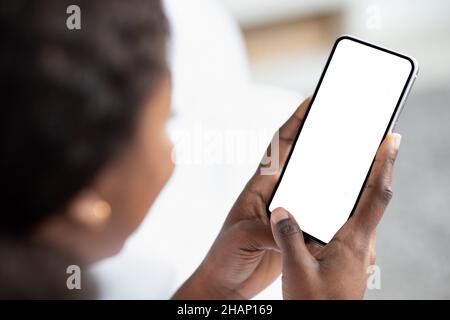 Unrecognizable black woman using smartphone with empty screen Stock Photo