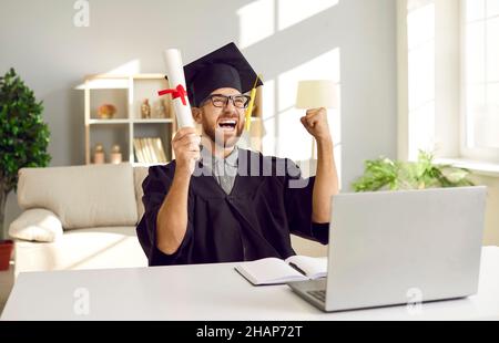 Excited student celebrate graduation from online university Stock Photo