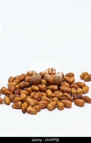 Mixed hazelnuts with shell and without it isolated on white background Stock Photo