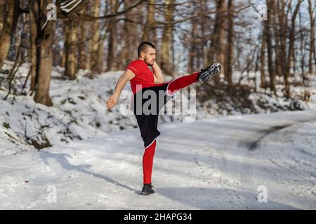 Strong muscular fighter sparring in nature at snowy winter day. Boxing, winter fitness Stock Photo