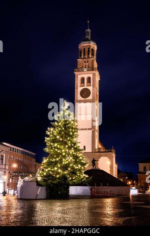Illuminated christmas tree at the historic Perlach church in Augsburg at night Stock Photo