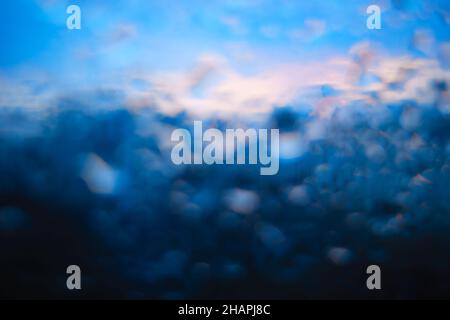 Raindrops on window glass bokeh background Stock Photo