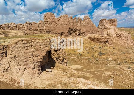 Eroded earthen walls of Ayaz Qala fortress in Kyzylkum desert, Uzbekistan Stock Photo