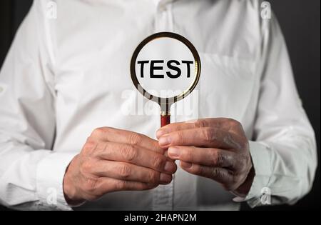 Word test on sticky note over gray and yellow background. Stock Photo
