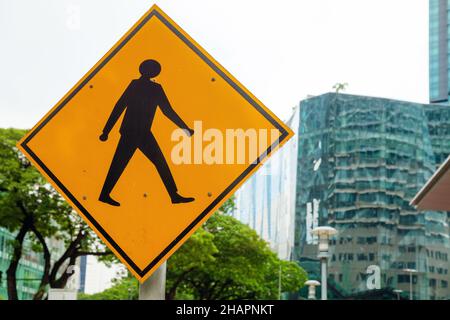 Pedestrian crossing, road sign mounted on a roadside in the city Stock Photo