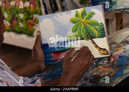 BAYAHIBE, DOMINICAN REPUBLIC - Jan 03, 2020: BAYAHIBE, DOMINICAN REPUBLIC 4 JANUARY 2020: Dominican painter paints