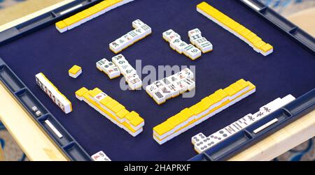 Many Mahjong tiles on on the playing field. An ancient asian game called Mahjong. Stock Photo