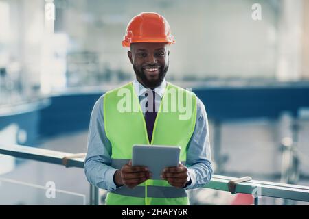 Smiling african american civil engineer with digital tablet Stock Photo